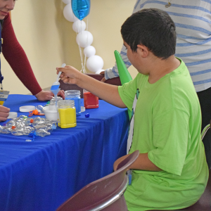 Jentzen, 11, makes some sand art. 
