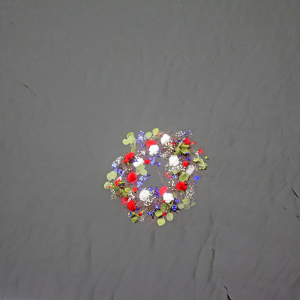The memorial wreath floating in the water. 