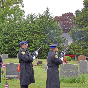 The Dartmouth Police Department performs a gun salute. 