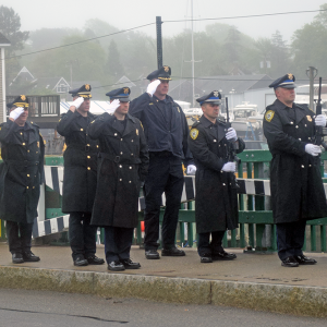 The Dartmouth Police Department performs a gun salute. 