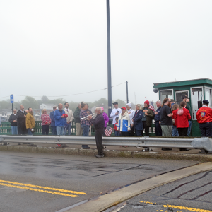 The crowd listens to a member of the Dartmouth Community Band perform "Taps."