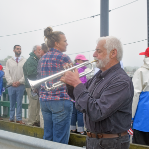 The crowd listens to a member of the Dartmouth Community Band perform "Taps."