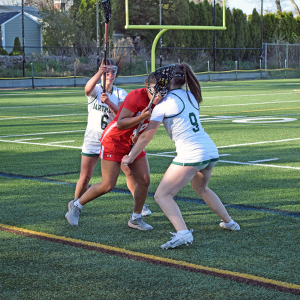 Laila Costa and Tenley Simmons block an opposing player. 
