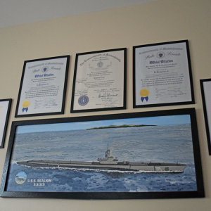 Citations and a painting of the Japanese battleship that Enos' submarine sunk. 