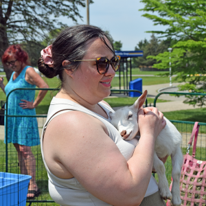 Rachel holding a baby goat.