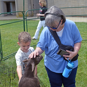 Colton walker, 5, and Colleen pet the goats. 