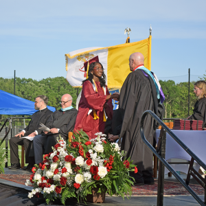 A student receives her diploma. 