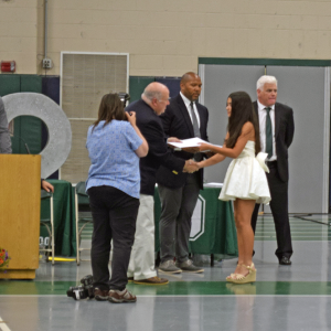 A student receives her diploma. 