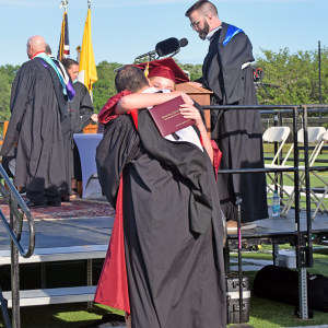 A student hugs a member of the Bishop Stang staff after she received herdiploma. 