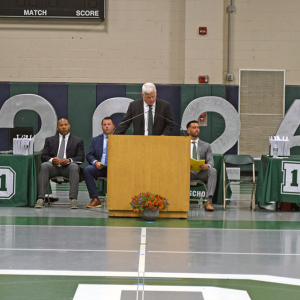 Peter Rossi welcomes the families and graduates. 