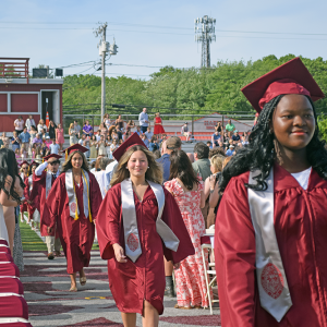 The students enter into the graduation. 