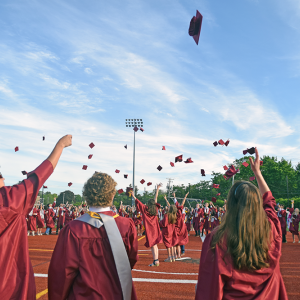 The students toss their caps in the air. Photos by Kat Sheridan
