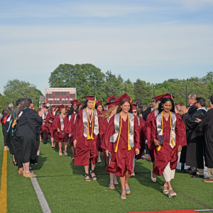 The students walk through the tunnel of faculty. 