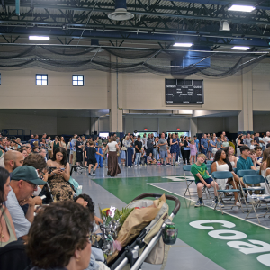 The crowd overspilled from the bleachers to the sides of the court. 