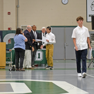 A student reveives his diploma. 