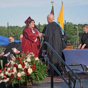 A student receives her diploma. 
