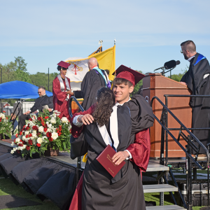 A student hugs a member of the Bishop Stang staff after he received his diploma. 