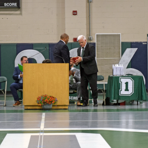 Marc Hayes gives Peter Rossi the Golden Apple. 