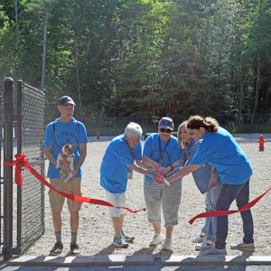 The Dog Advisory Work Group cuts the ribbon to open the park. 
