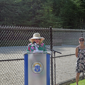 Select Board Chair Heidi Silva-Brooks welcomes people to the park. 