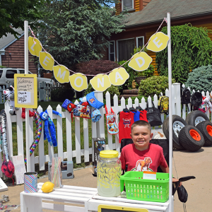 Adrian Rodriguez, age 7, selling lemonade at mhsi mom's yard sale. 