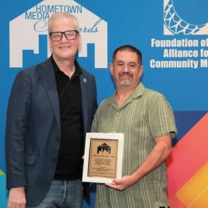 Peter Chasse accepting the award from Mike Wassenaar, the President and CEO of the Alliance for COmmunity Media. Source: Alliance for Community Media