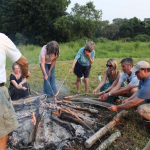 A group roasts hot dogs around the fire. Photos by Kat Sheridan