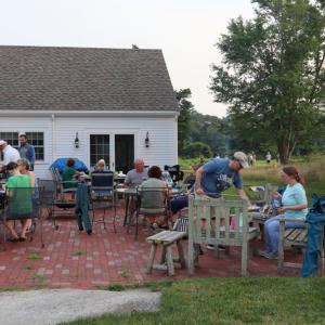 The DNRT, with people eating and the bonfire in the background. 