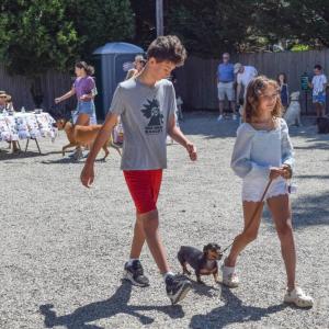 Florie and her brother walk their dachshund. 