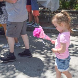 Rose, 3, carries her flowers. 