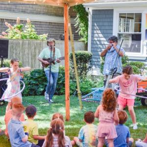 Two kids compete in a hula hoop contest held by the Toe Jam Puppet Band. 