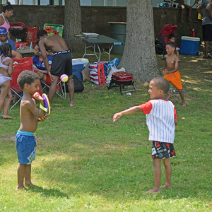 Two kids play during the BBQ. 