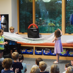 Arlo and Riley show off the dino they pulled from the bag. 