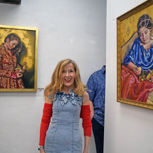 Deborah Macy poses with a couple of her paintings. Photos by Kat Sheridan