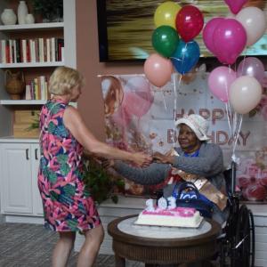 Nellie Jackson dances with one of the staff members. 
