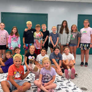 The group poses with Joey, the two-legged dog. Source: Traci Martin