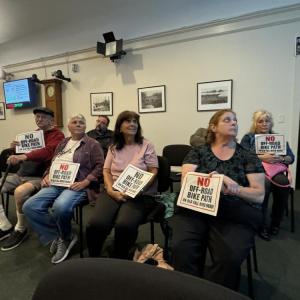Residents with their signs. Photo by Kat Sheridan