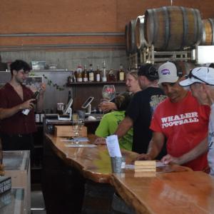 Bikers and friends enjoy drinks at Running Brook Vineyards. 