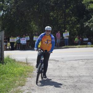 Scott Kane, from Lynn, bikes into the vineyard. 