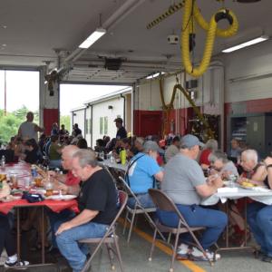 The crowd at Fire District 3 enjoys the pig roast. Photos by Kat Sheridan
