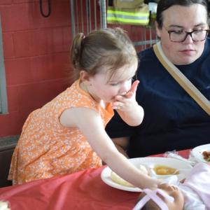 Magnolia Seland, age 2, enjoys the pulled pork. 