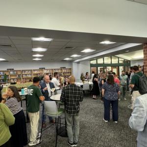 The new teachers, School Committee and mentors mingle. 