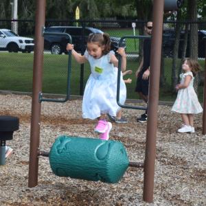 Claire, 5, runs on a playground toy.