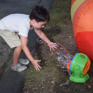 Everett, 6, plays with a bubble machine. 