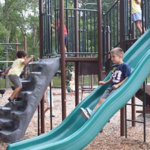 Conner, 6, slides down the slide. 