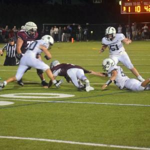 A Dartmouth player attempts to get the ball away from a Bishop Stang player. 