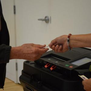 A voter gets an "I Voted" sticker. 