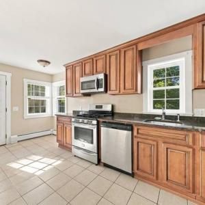 Kitchen with wood cabinets, a gas range and stainless dishwasher at 17 Beeden Road, Westport, MA