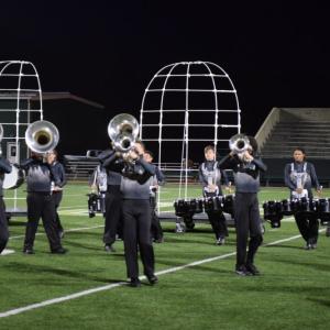 The wind section marches across the field. 