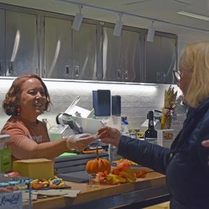 Quiggs hands out samples of cheeses. 